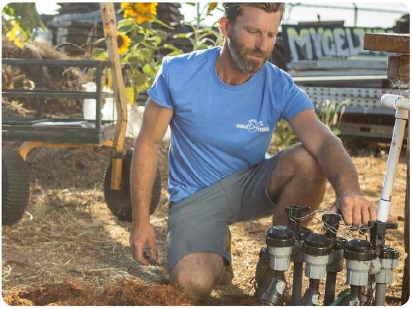 Man with a beard installing a Rain Bird irrigation system